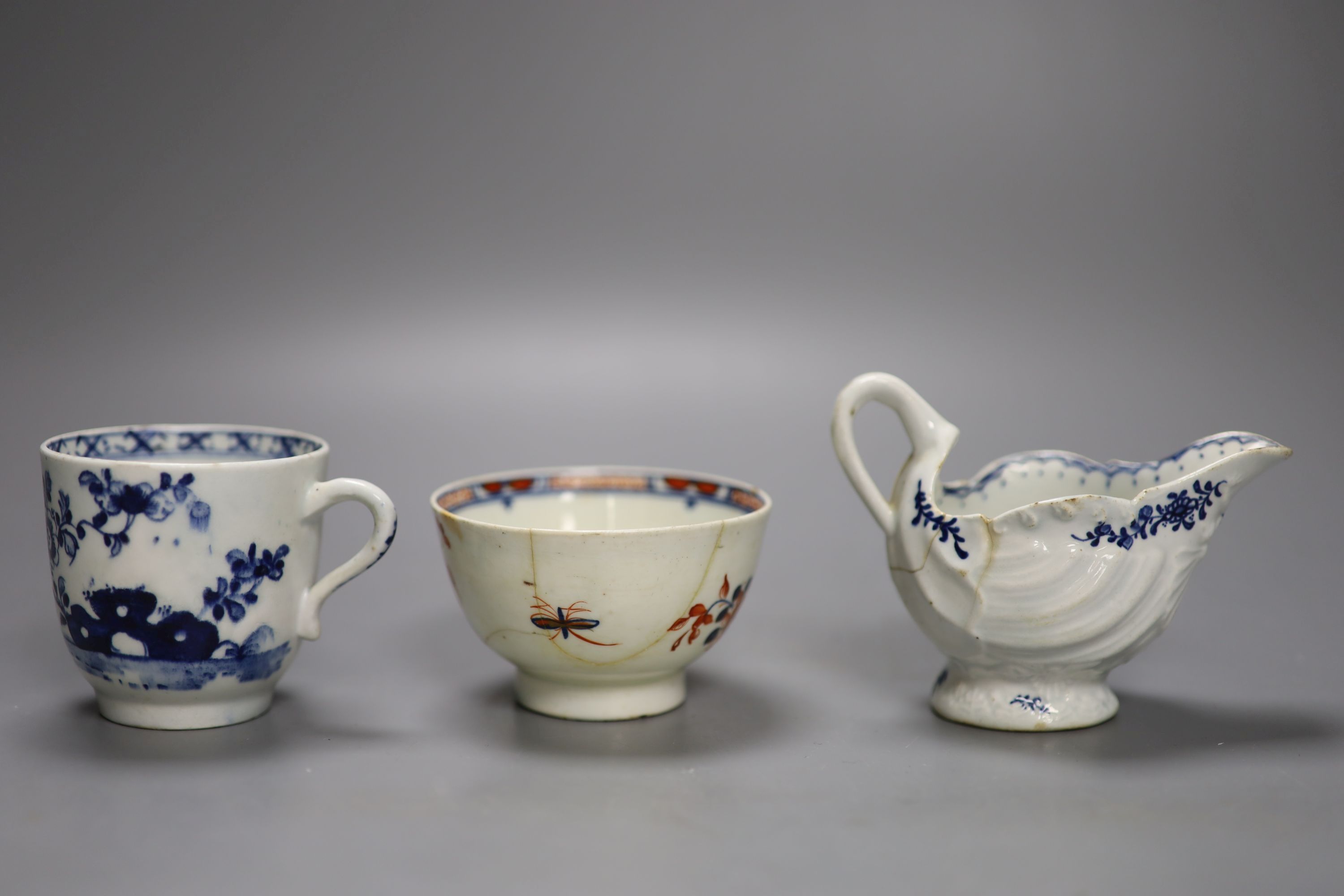 A Lowestoft shell moulded ewer painted with floral sprigs, a Lowestoft coffee cup,